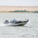 Motor boat travels across a lake